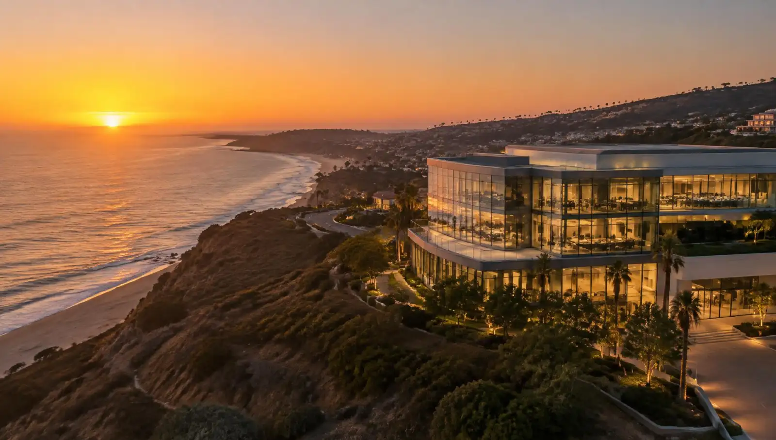 Illustrative image of a coastal bluff and a modern building at sunset